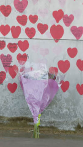 Vertical-Video-Of-The-National-Covid-Memorial-Wall-In-London-UK-With-Flowers